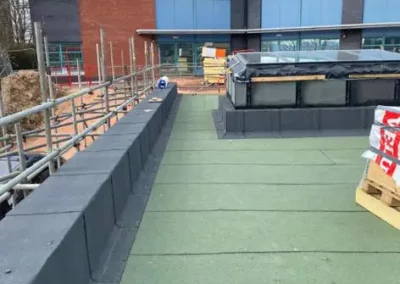 Building with green rooftop under construction